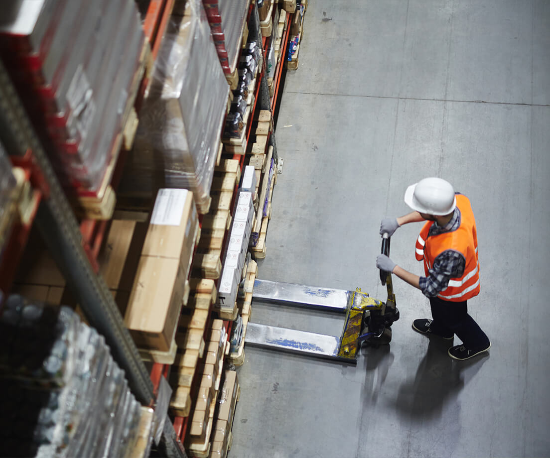 Top-down view of warehouse worker using forklift