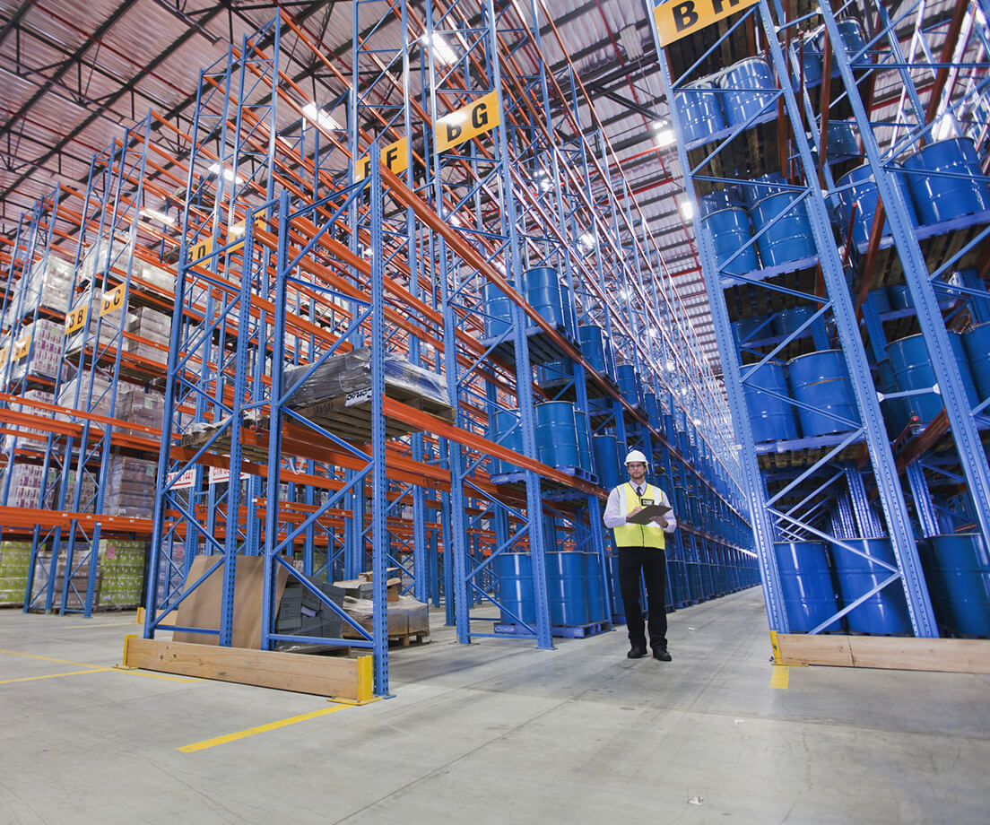 Worker standing in large warehouse